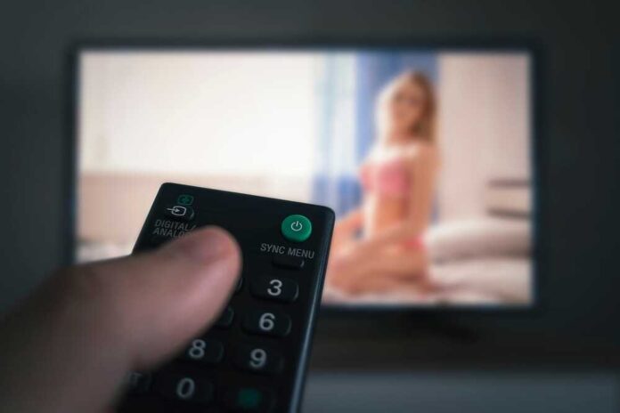 Porn,Tv,-,Pornography.,Remote,Control,In,A,Man's,Hand