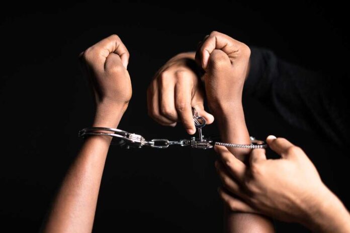 Close,Up,Shot,Of,Hands,Removing,Cuffs,From,Hand,On