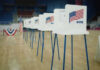Voter Purge Fury: SAVE Act’s Controversial Push Voting booths lined up in a gymnasium.
