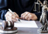 Gavel statue of justice person writing document