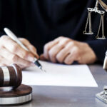 Gavel statue of justice person writing document