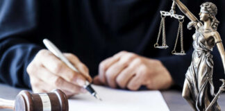 Gavel statue of justice person writing document