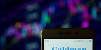 Phone displaying Goldman Sachs logo in front of chart