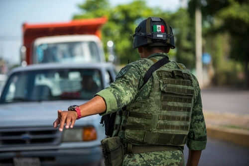 Soldier directing traffic on a busy road