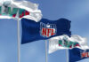 Four flags with NFL and Super Bowl LVII logos.