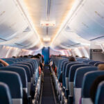 Interior view of airplane cabin with passengers