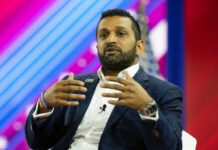 FBI Director’s Shocking Move: Trump Critics Targeted Person speaking on stage with colorful background