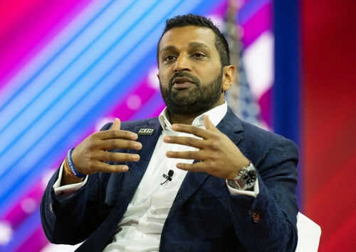 Person speaking on stage with colorful background