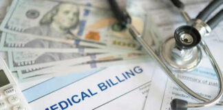 Stethoscope calculator and money on medical billing papers