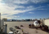 Airport runway with airplane and Las Vegas skyline.