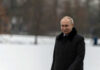 PUTIN THREATENS Europe Gas Shutoff Person in dark coat standing on snowcovered ground