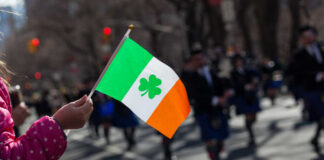 Child holding an Irish flag during a parade