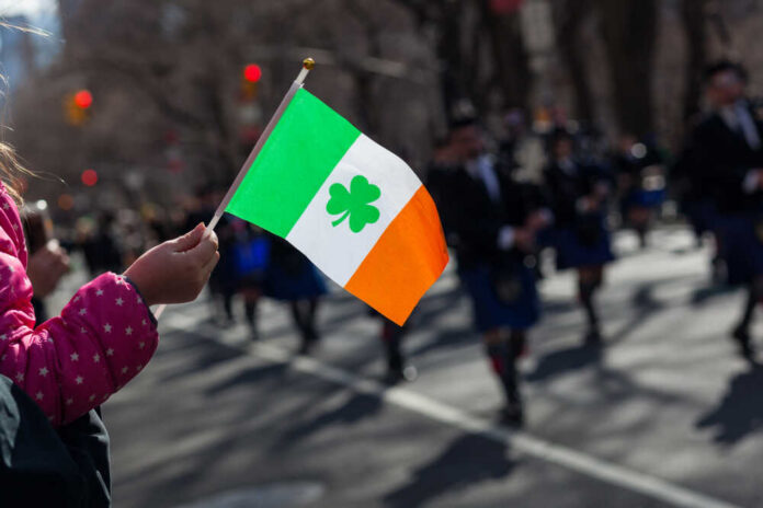 shutterstock_1343221292.jpg Child holding an Irish flag during a parade