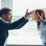 Two individuals engaged in a heated argument in an office environment