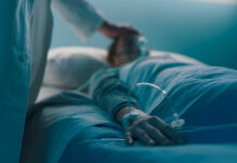 Vulnerable at Risk: Assisted Suicide Bill Halted A medical professional attending to a patient in a hospital bed