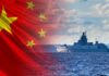 Beijing’s Undersea Strategy: America’s Blind Spot A Chinese naval ship sailing on the ocean with the Chinese flag in the background