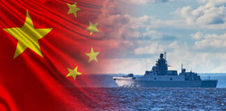 A Chinese naval ship sailing on the ocean with the Chinese flag in the background