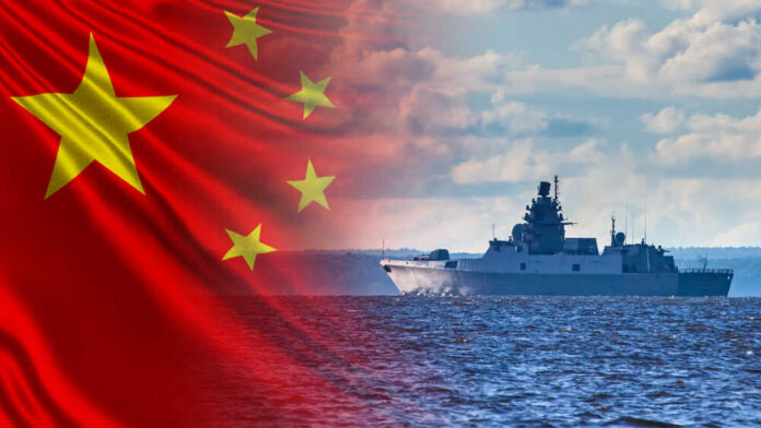 A Chinese naval ship sailing on the ocean with the Chinese flag in the background
