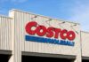 Exterior view of a Costco Wholesale store sign against a blue sky