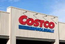 Exterior view of a Costco Wholesale store sign against a blue sky