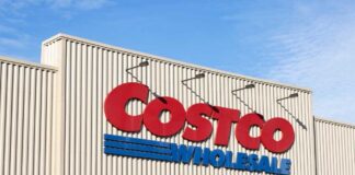 Exterior view of a Costco Wholesale store sign against a blue sky