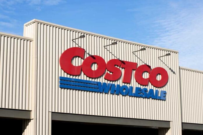Exterior view of a Costco Wholesale store sign against a blue sky