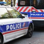 Two police vehicles parked on a city street