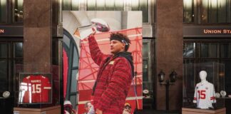 Display of Kansas City Chiefs memorabilia with a large poster of a player holding a trophy
