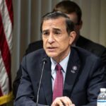 Darrell Issa Bows Out, Leaves GOP Scrambling A government official speaking at a meeting with an American flag in the background