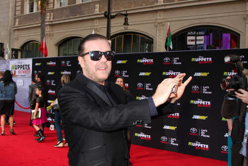 A man in sunglasses poses on the red carpet at a celebrity event