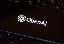 Close-up of a smartphone displaying the OpenAI logo on a dark screen
