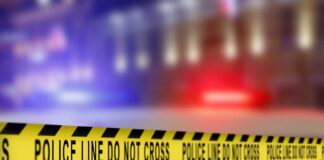 Yellow police caution tape with the text 'POLICE LINE DO NOT CROSS' in a blurred background