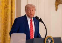 Trump’s Surprise Iran Attack: Allies Left in the Dark A man in a suit speaking at a podium in a formal setting