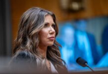 Shield of the Americas—Trump’s Secret Weapon? A woman testifying in a government hearing with a serious expression