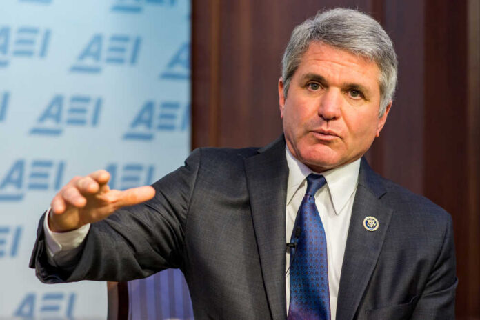 A man in a suit speaking during a conference