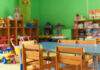 School Scandal EXPOSED: Aide’s Hostile Pattern Brightly colored classroom with wooden tables and shelves filled with toys