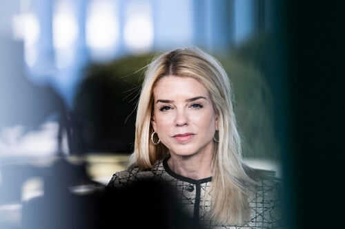 Woman with long blonde hair wearing hoop earrings