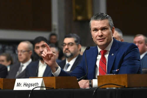 Man speaking at a panel discussion meeting