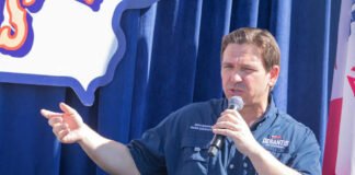 Person speaking into microphone during public event