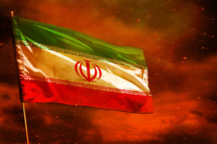 Iranian flag waving against a dramatic orange sky