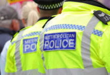 Two police officers in high-visibility jackets at a public event