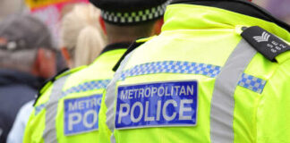 Two police officers in high-visibility jackets at a public event