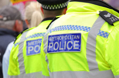 Two police officers in high-visibility jackets at a public event