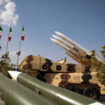 Is Iran the New Vietnam? Warnings Ignored Military missiles displayed outdoors with Iranian flags in the background