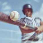 A baseball player swinging a bat at a baseball