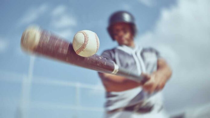 A baseball player swinging a bat at a baseball