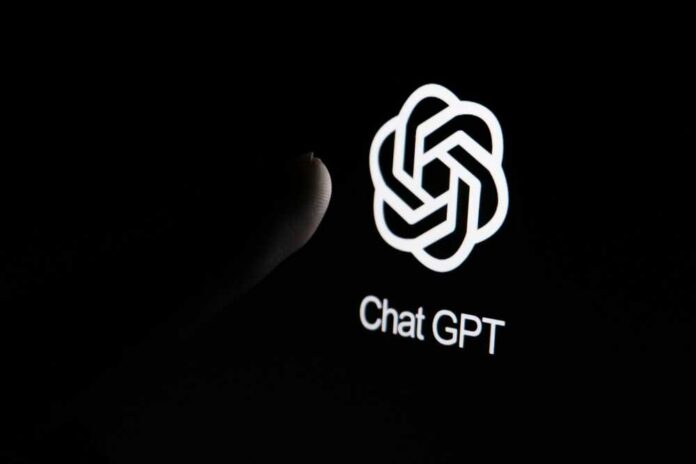 shutterstock_2370540011.jpg Close-up of a hand reaching towards the ChatGPT logo on a smartphone screen