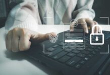 Person using a laptop with biometric login interface