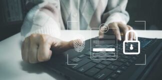 Person using a laptop with biometric login interface