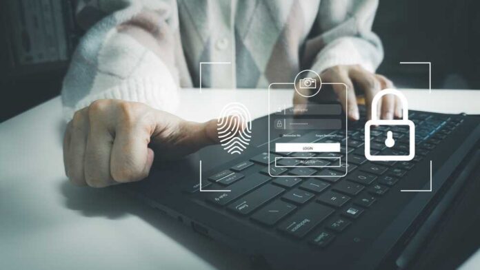 Person using a laptop with biometric login interface